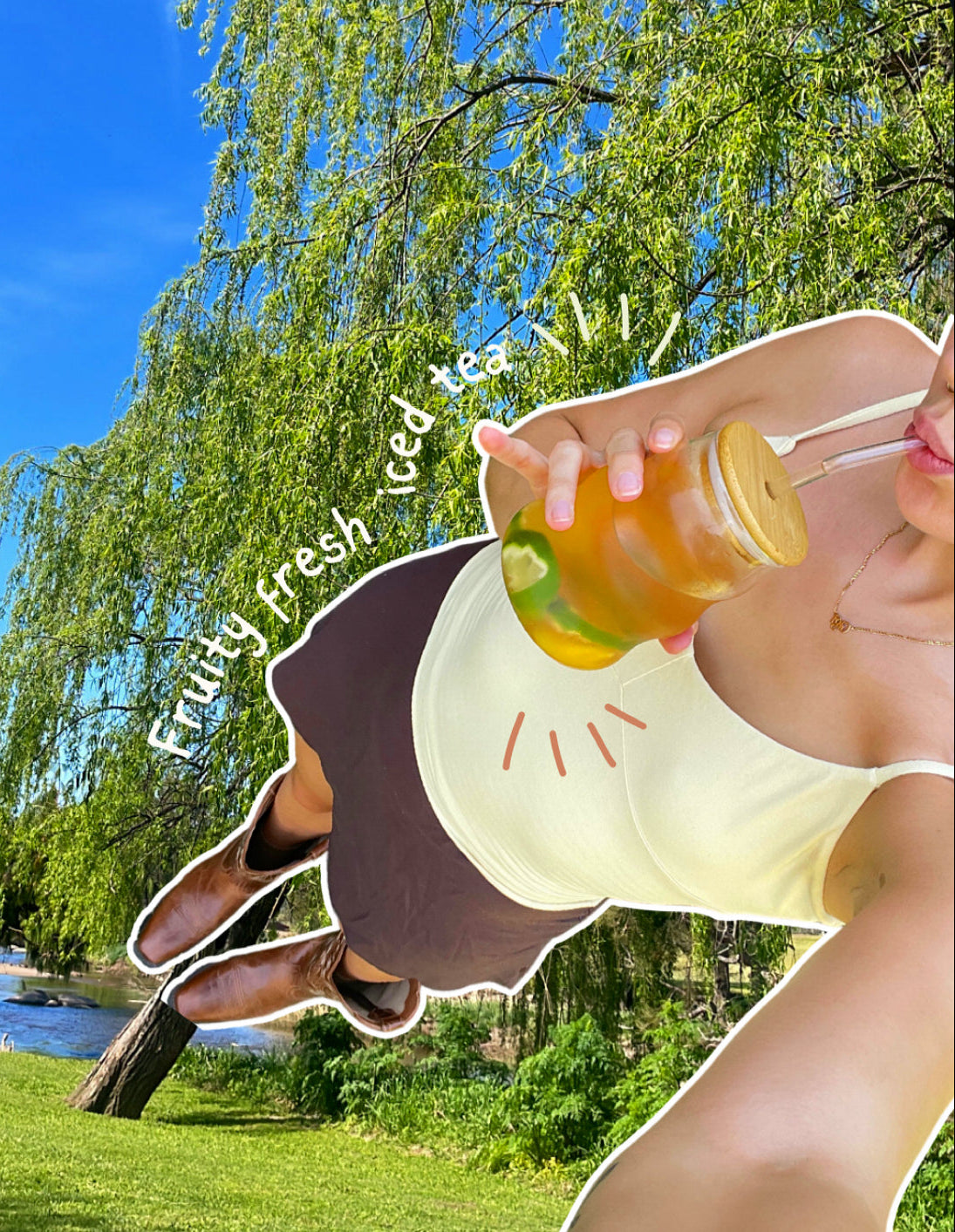 Person drinking iced tea outdoors with trees and blue sky in the background